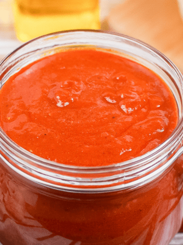 red enchilada sauce in a glass jar.