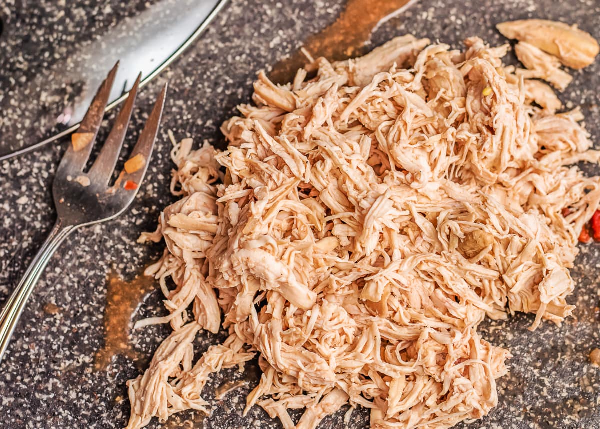 shredded chicken on a cutting board.