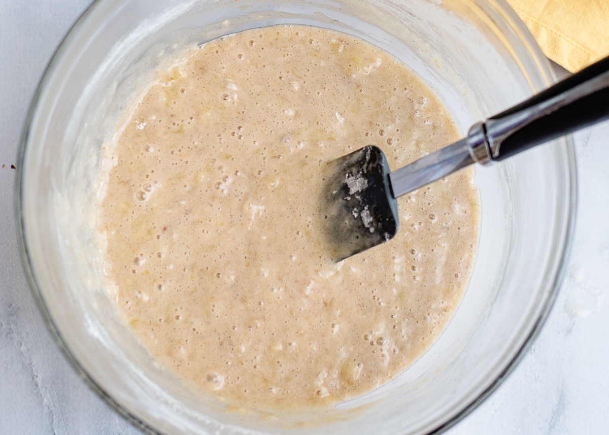 banana nut cake batter in a bowl with a rubber cake spatula.