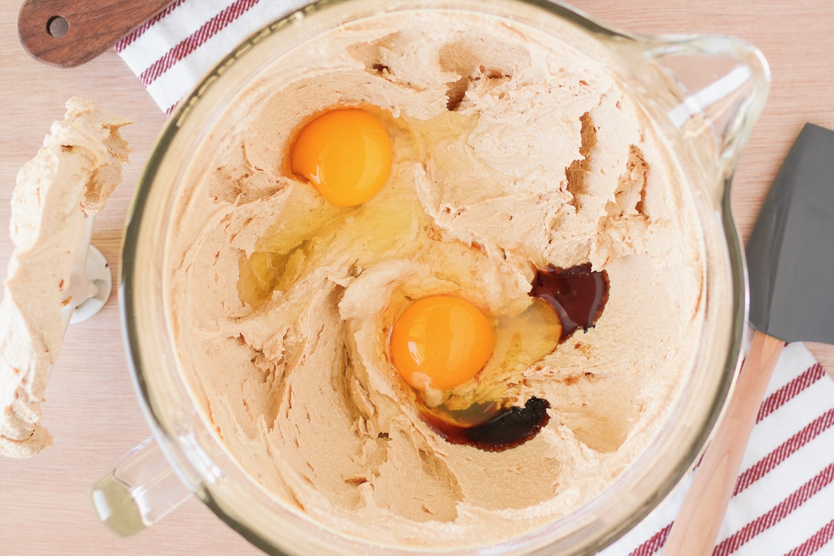 creamed butter in a stand mixer bowl with vanilla extract and 2 eggs added.