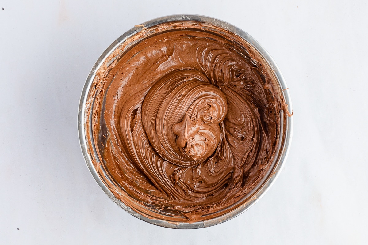 freshly made chocolate frosting in a stainless steel bowl.