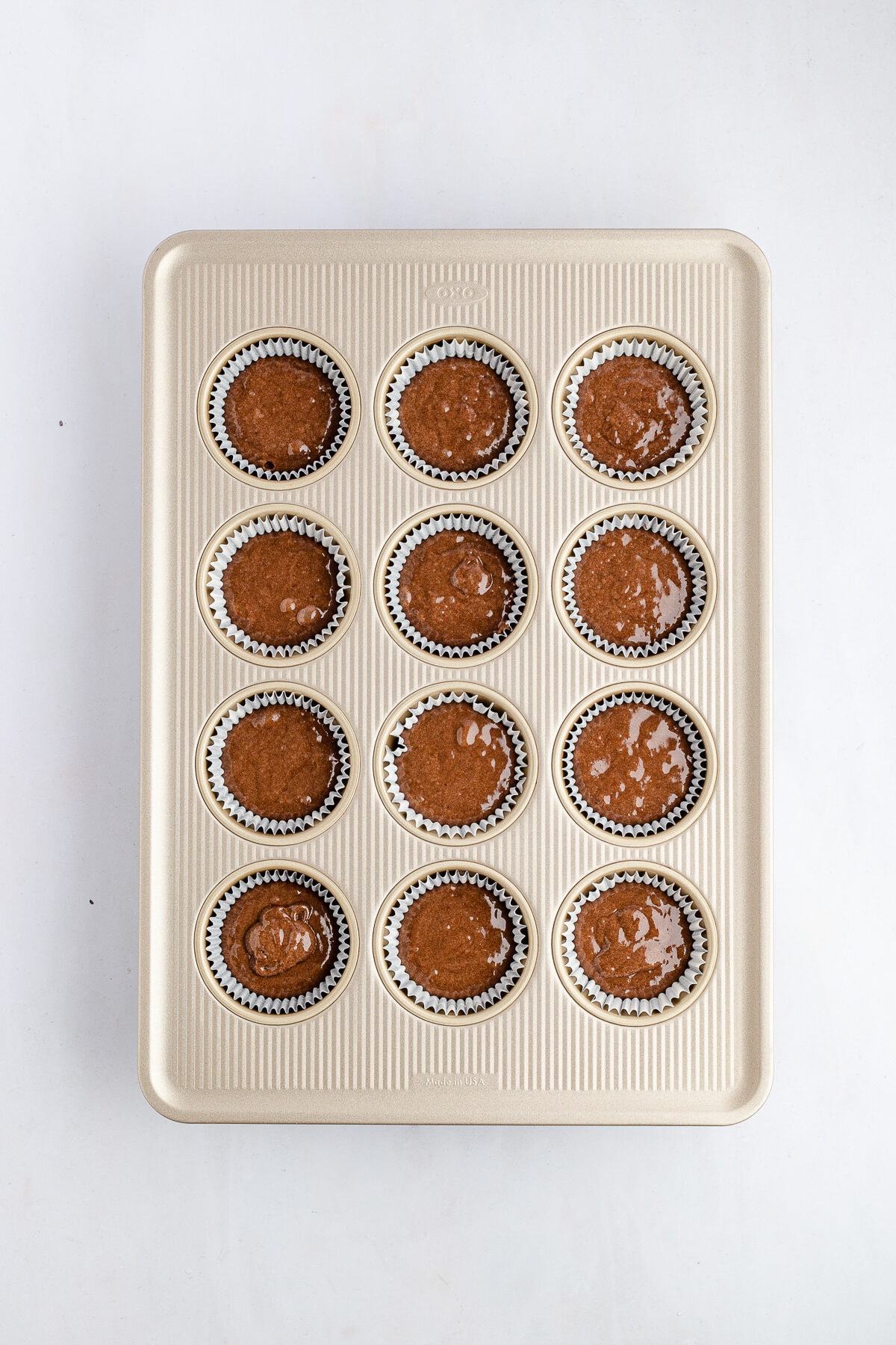 unbaked cupcake batter in a muffin tin.