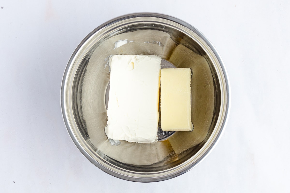 cream cheese and butter in a stainless steel bowl.