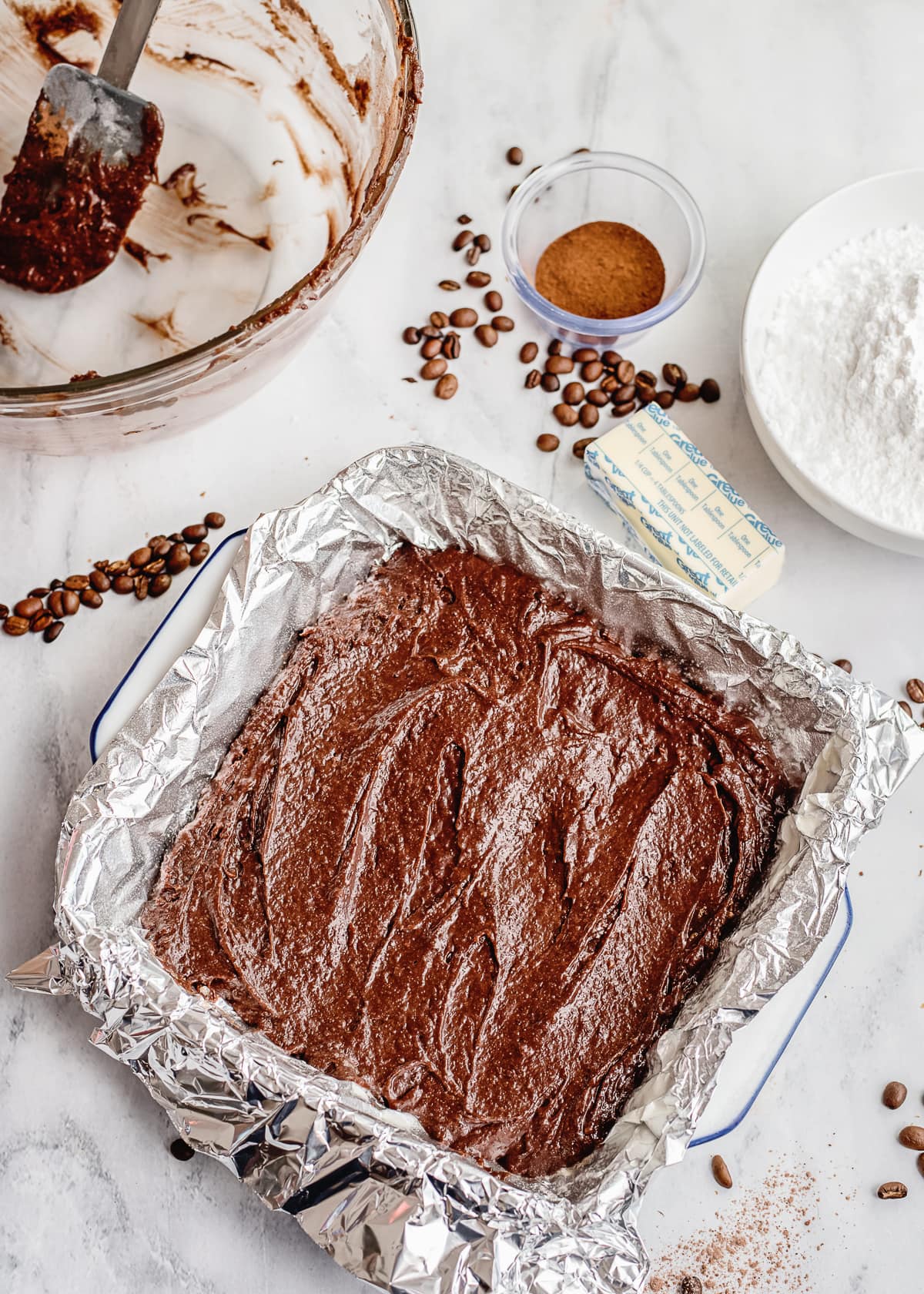 brownie batter in a foil lined baking pan.