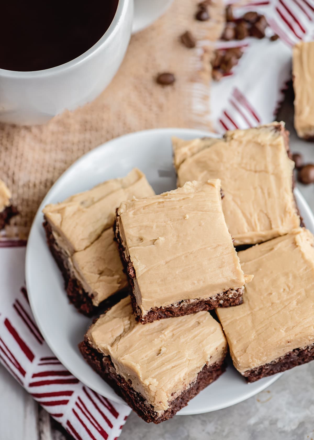frosted coffee brownies sliced and placed on a plate.