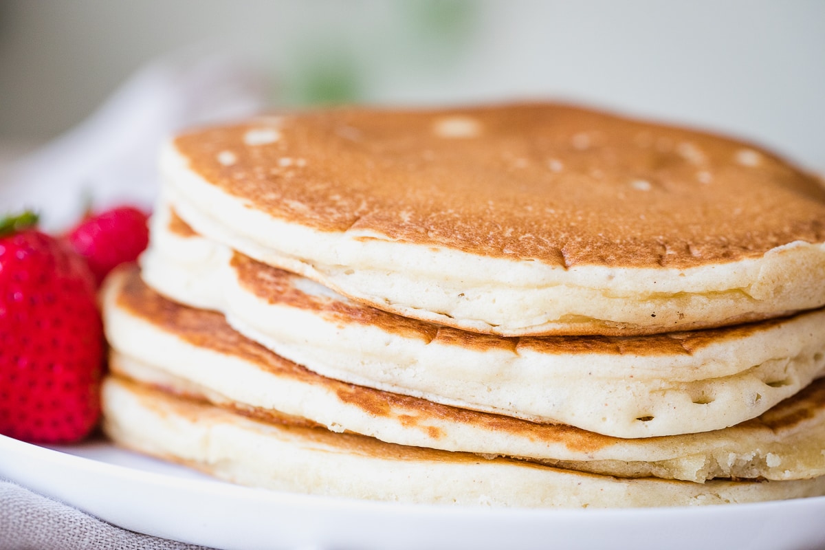 stack of dairy free pancakes on a white plate.