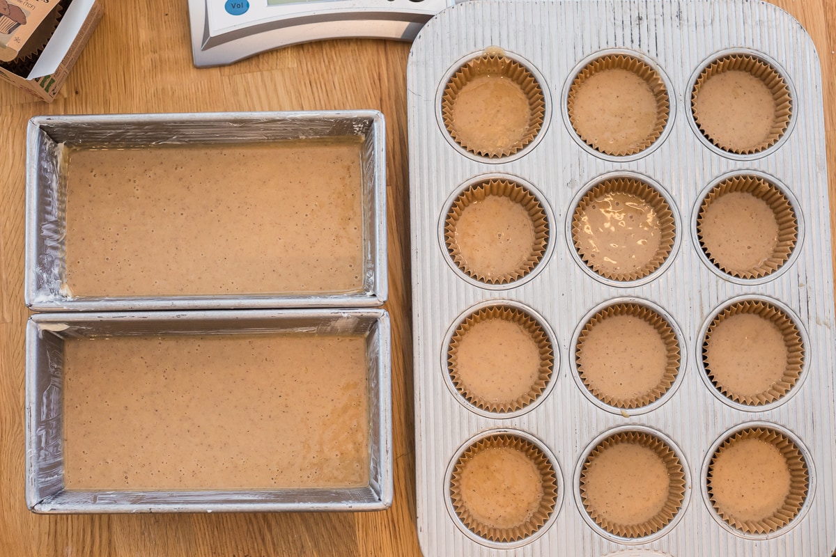 honey cake batter in 2 loaf pans and a muffin tin