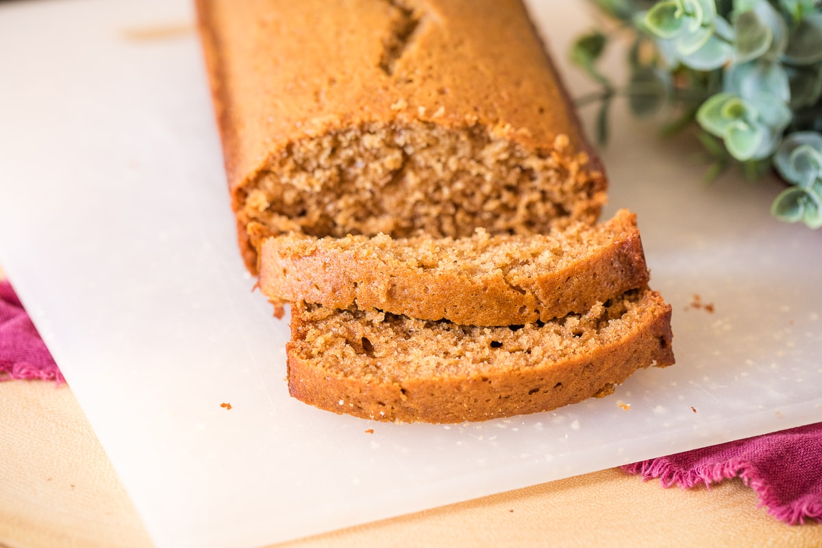 close up of honey cake for rosh hashanah on a cutting board with two slices.