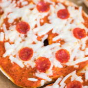 pizza bagel with mini pepperoni on it.