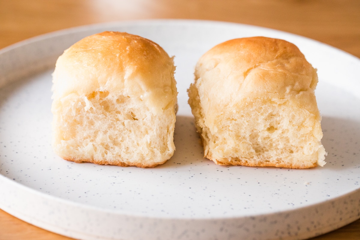 dinner rolls on a plate showing rolls with bread flour on the left and all-purpose flour on the right.