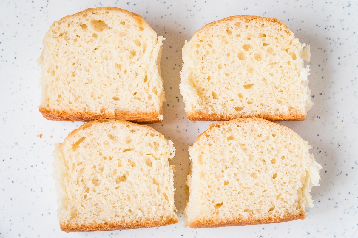 dinner rolls cut open on a plate showing rolls with bread flour on the left and all-purpose flour on the right.