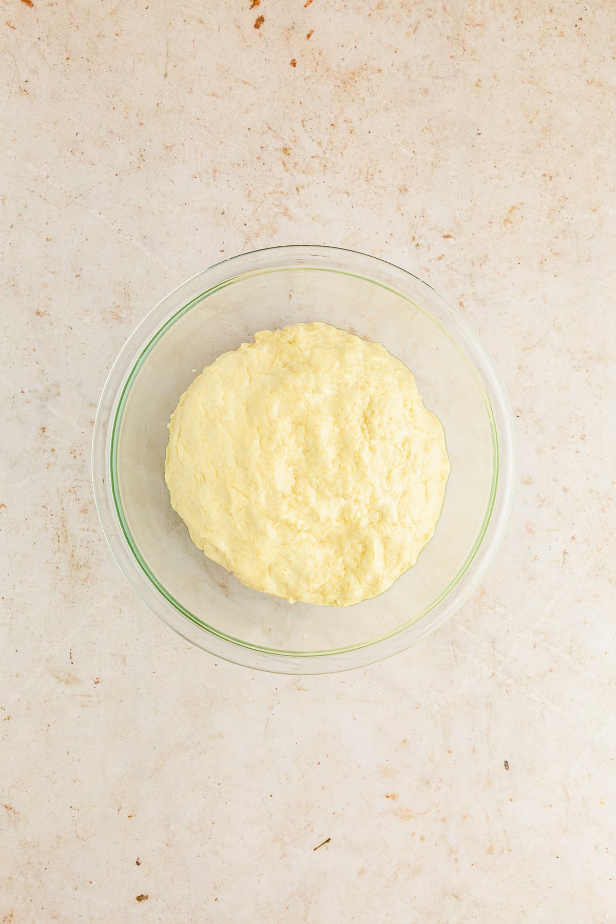 bread dough in a greased glass bowl.