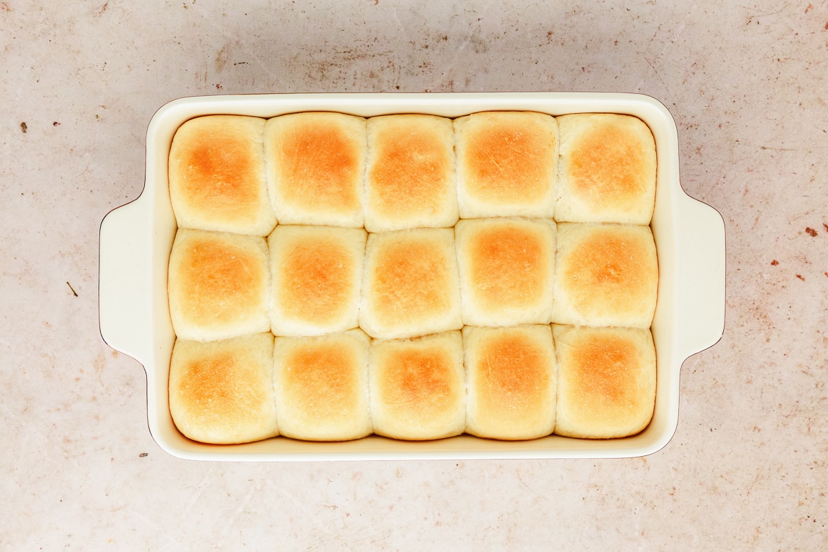 fresh baked dinner rolls in a ceramic baking dish.