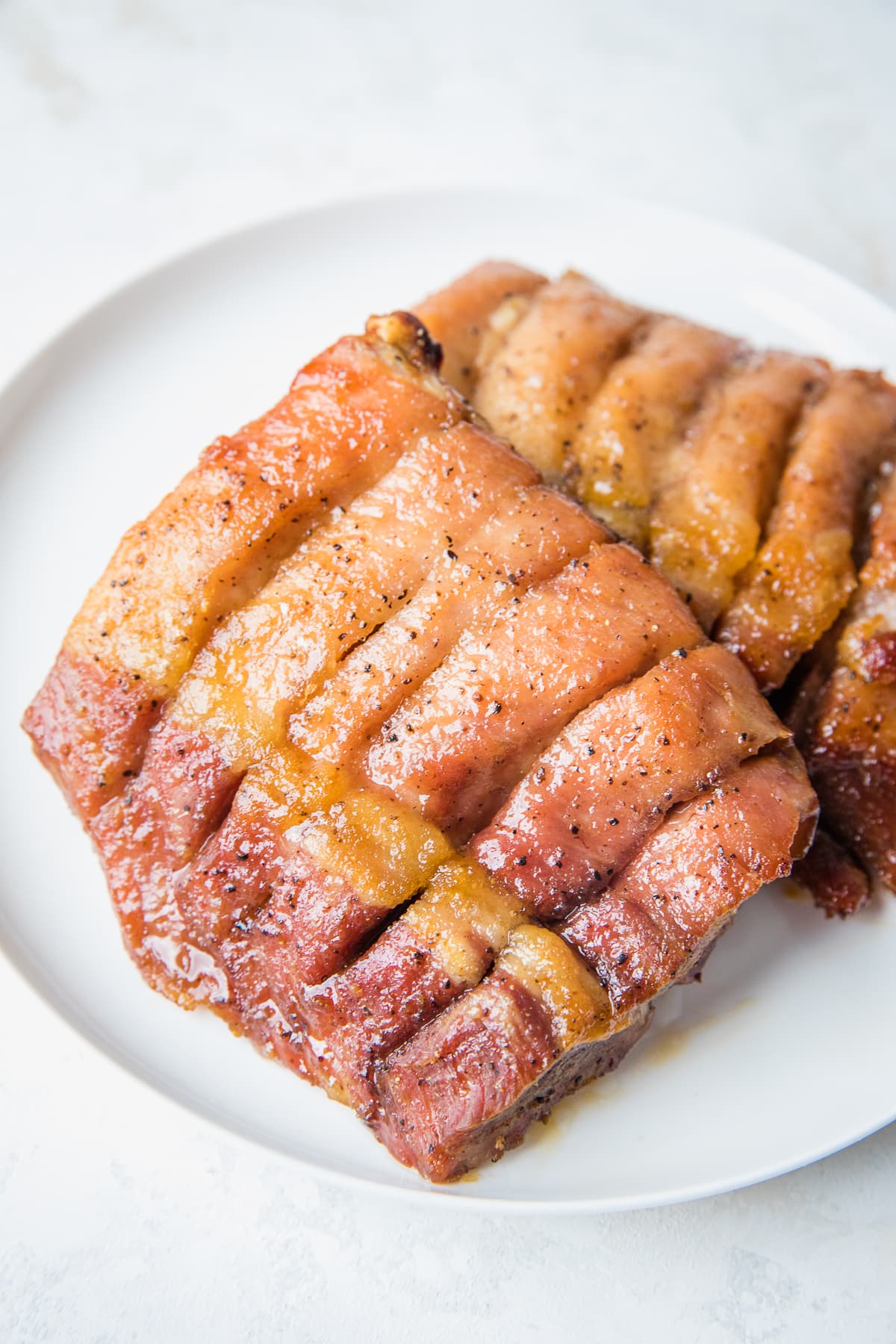 boneless pork ribs on a white plate.