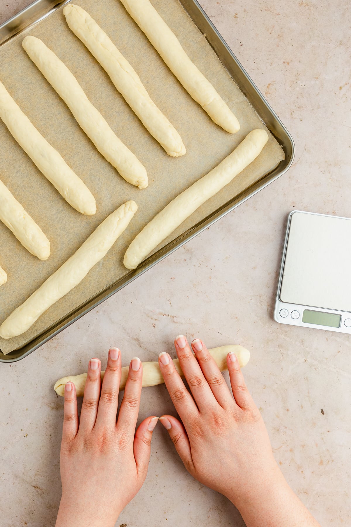 hand rolling breadsticks.