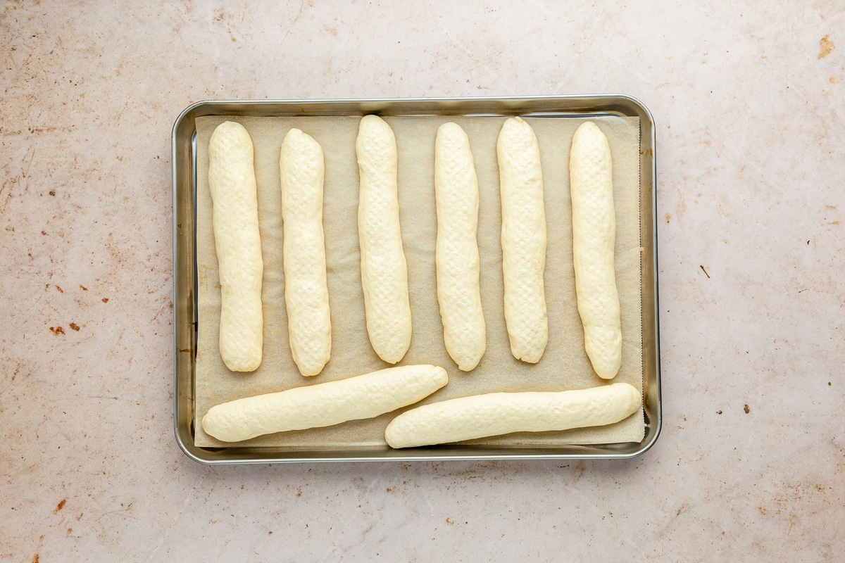 parbaked breadsticks on a baking sheet.