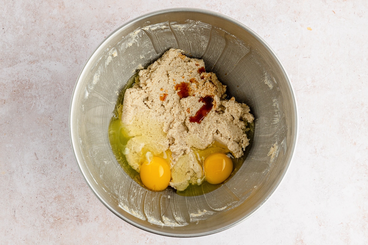 eggs and vanilla added to sugar mixture in bowl.