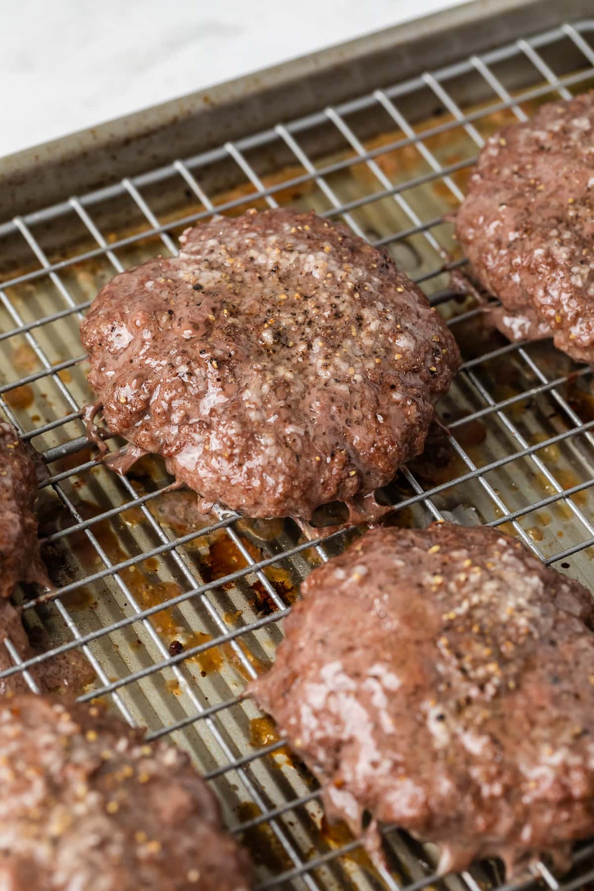 baked hamburgers on a wire rack.