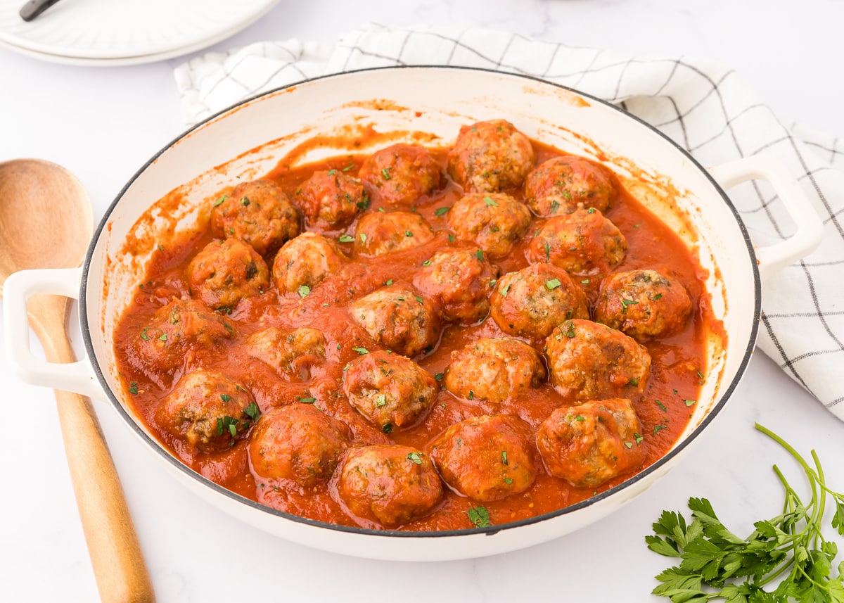 white pan of sauced meatballs.