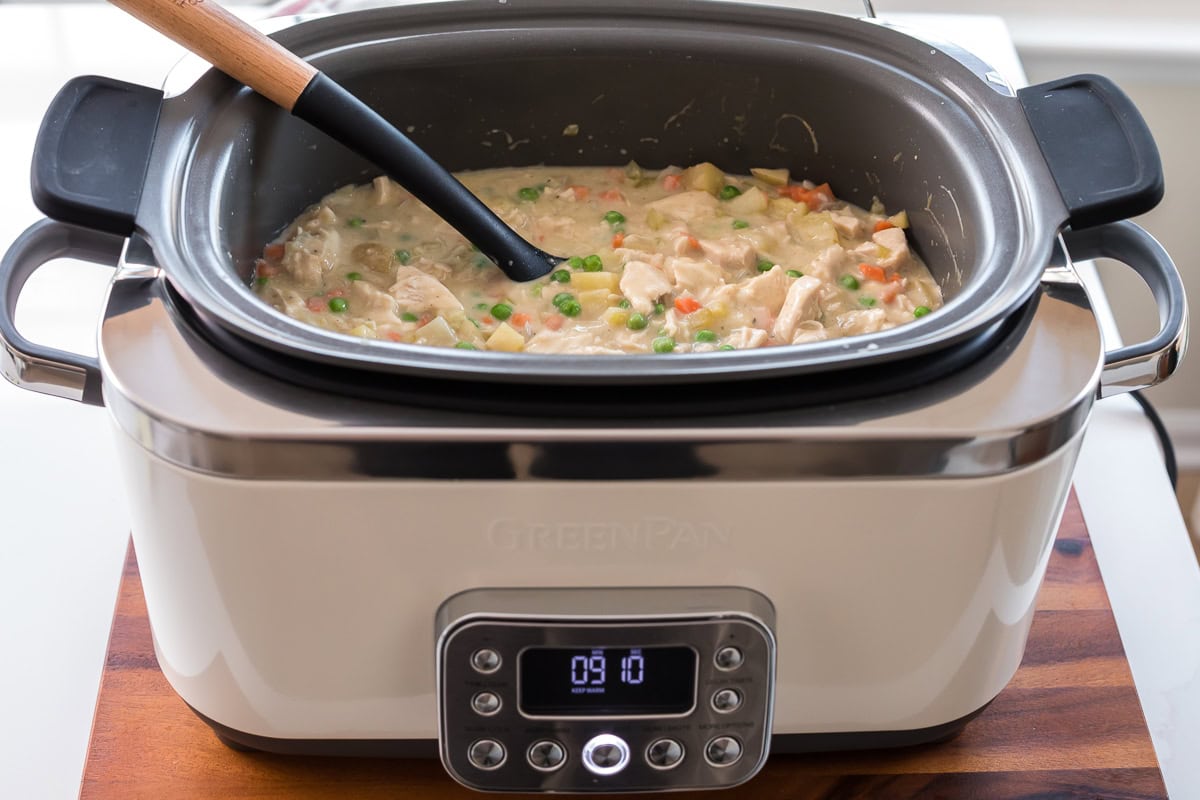 Slow cooker filled with homemade chicken pot pie ready to serve.