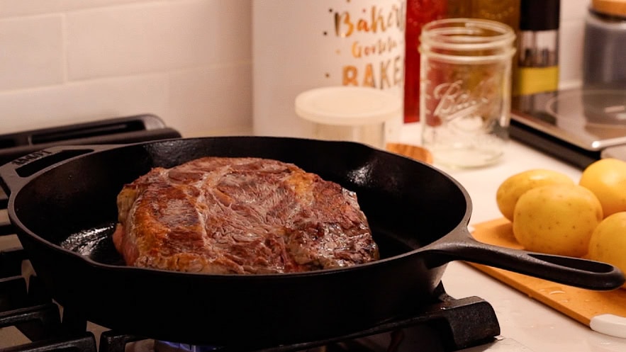 seared chuck roast in cast iron skillet.
