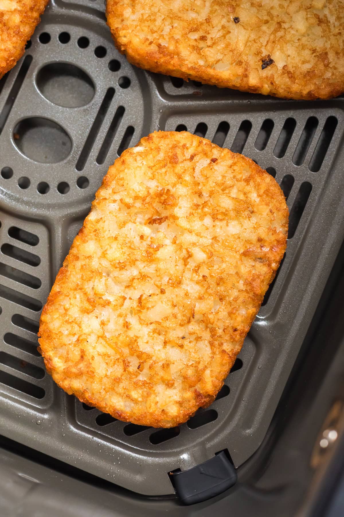 air fryer frozen hash browns cooked in basket.