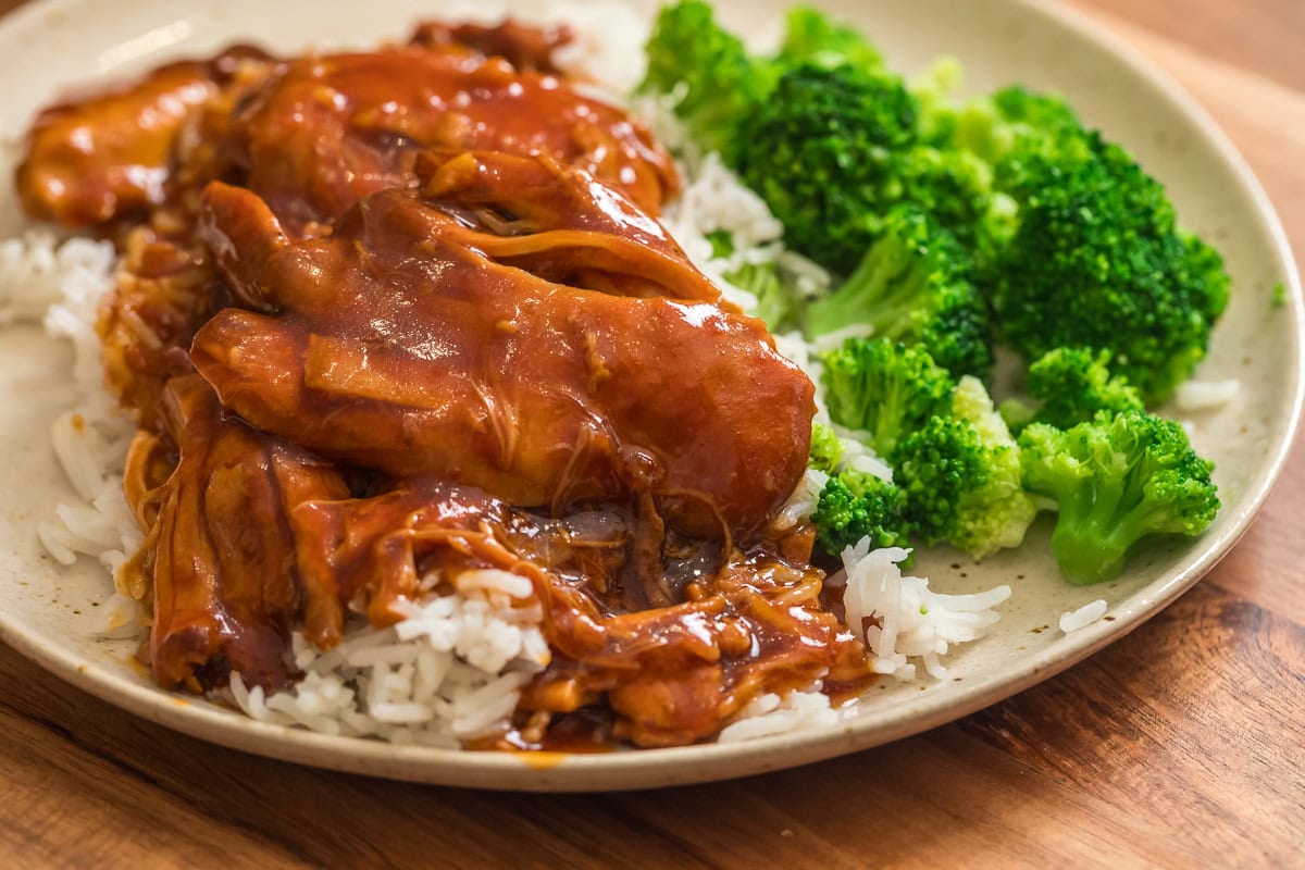 Close-up of the chicken over rice with broccoli, showing the honey garlic bbq sauce.