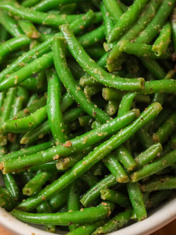 Garlic green beans cooked from frozen green beans in a white bowl.