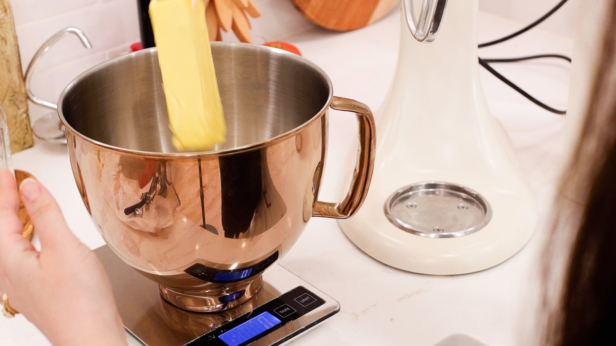 stick of butter dropping into mixing bowl.