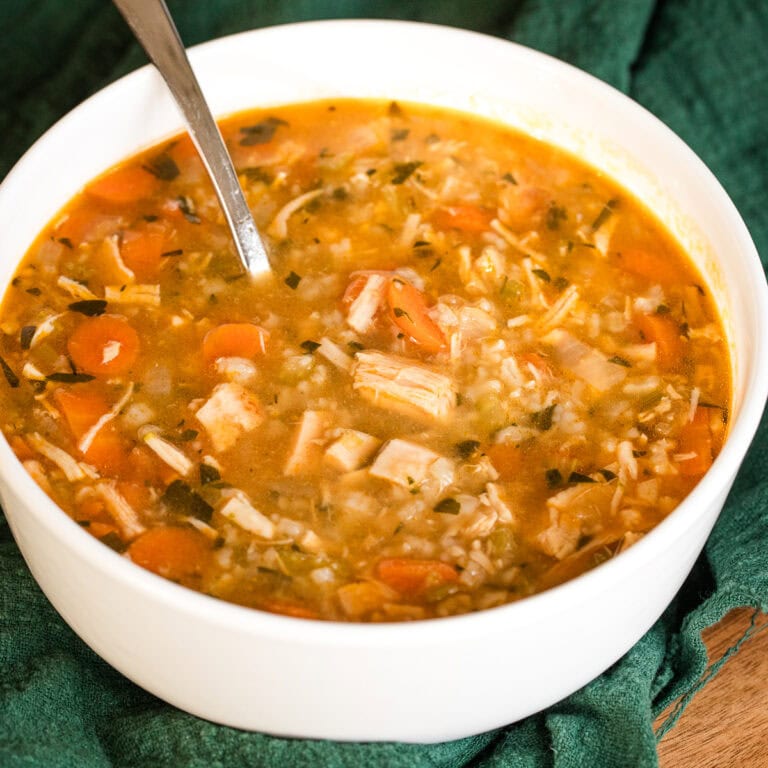 homemade rotisserie chicken and rice soup in a white bowl.