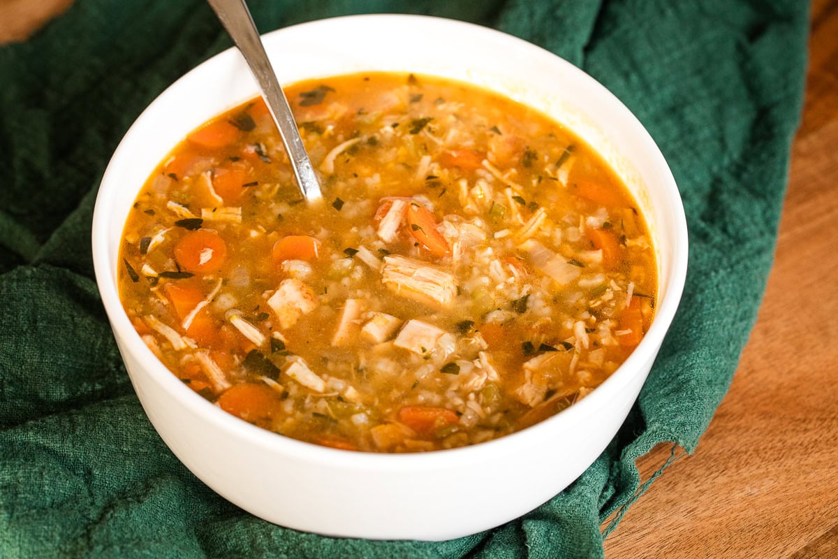rotisserie chicken and rice soup in a white bowl.