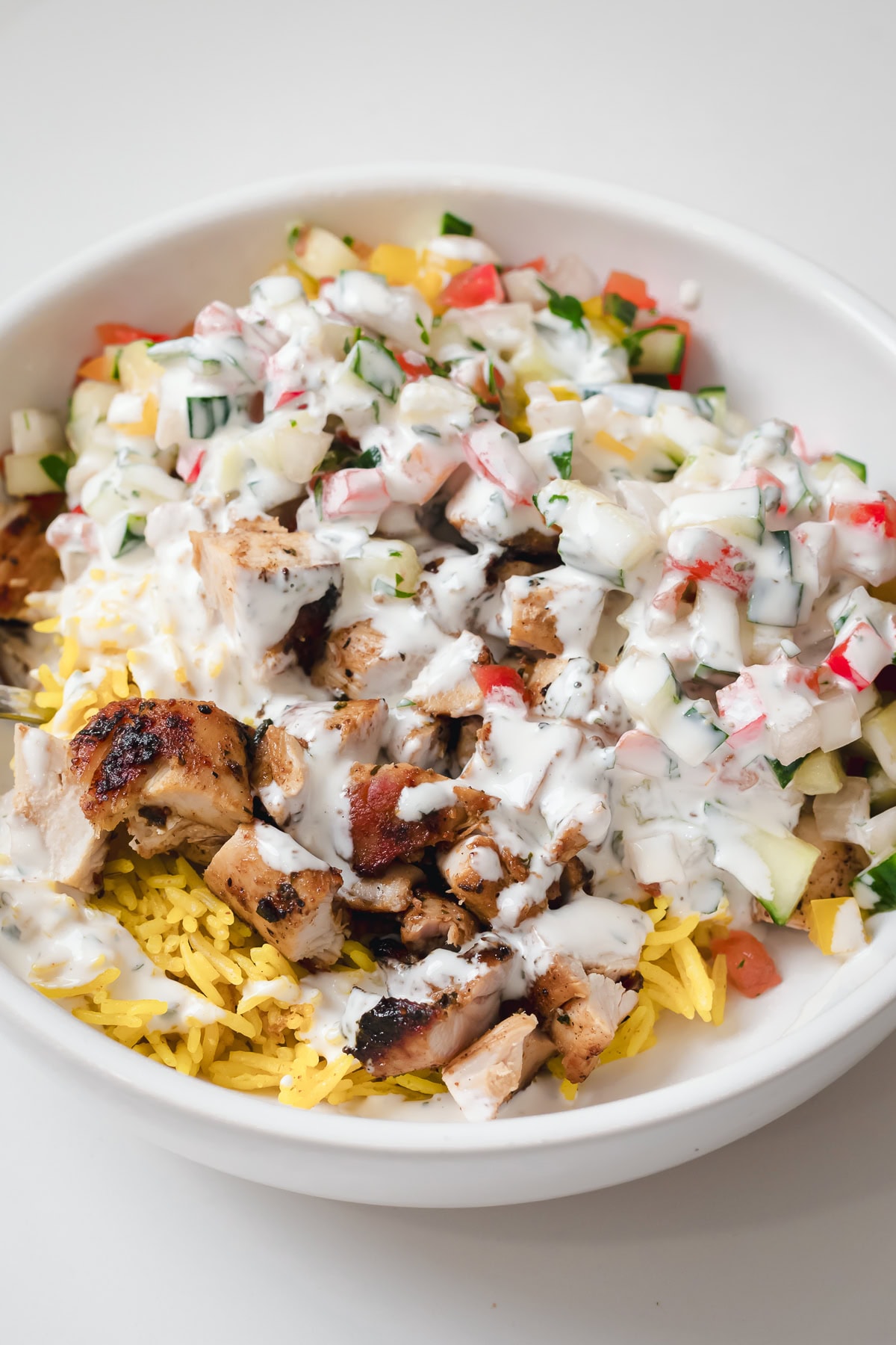 close up of halal cart chicken and rice in white bowl.