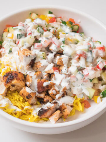 fresh halal cart chicken and rice in white bowl.