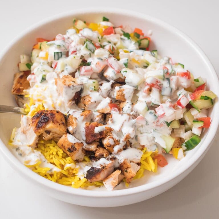 fresh halal cart chicken and rice in white bowl.