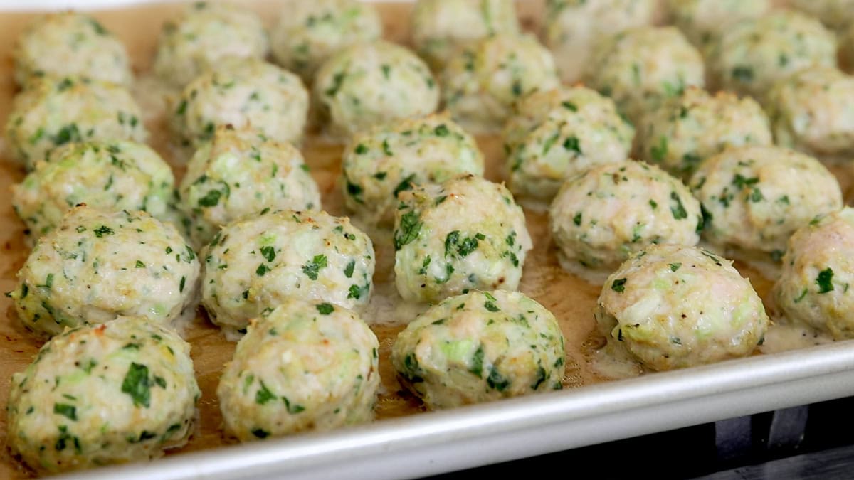fresh baked chicken meatballs on a baking sheet.