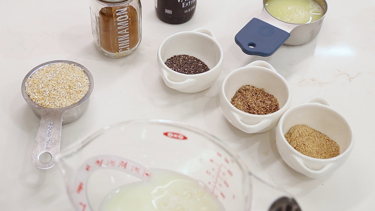 high fiber oat bran bowls ingredients in small containers and measuring cups.