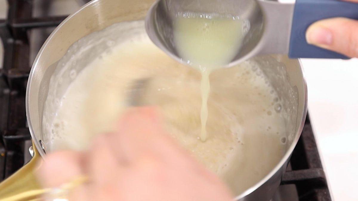 Adding liquid egg whites to oat bran while whisking to keep the texture creamy