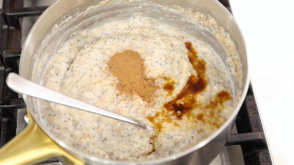 Creamy oat bran breakfast bowl cooking on the stove with cinnamon and vanilla added.