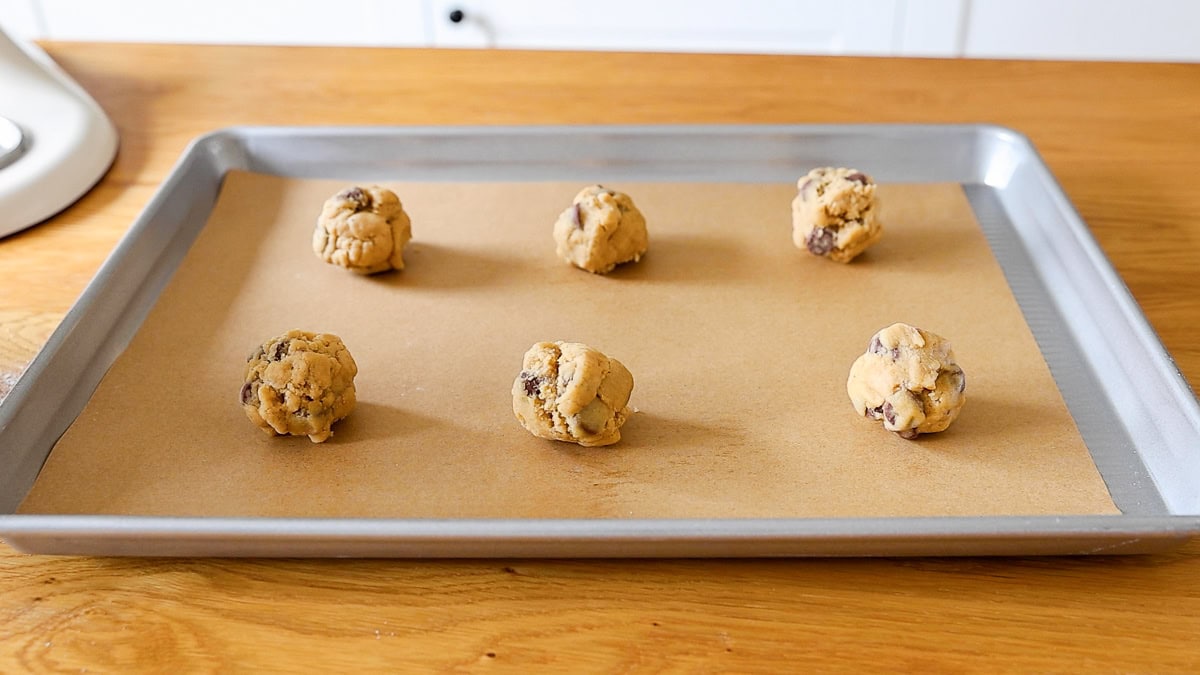 raw cookie dough with fresh milled flour on a parchment lined baking sheet.