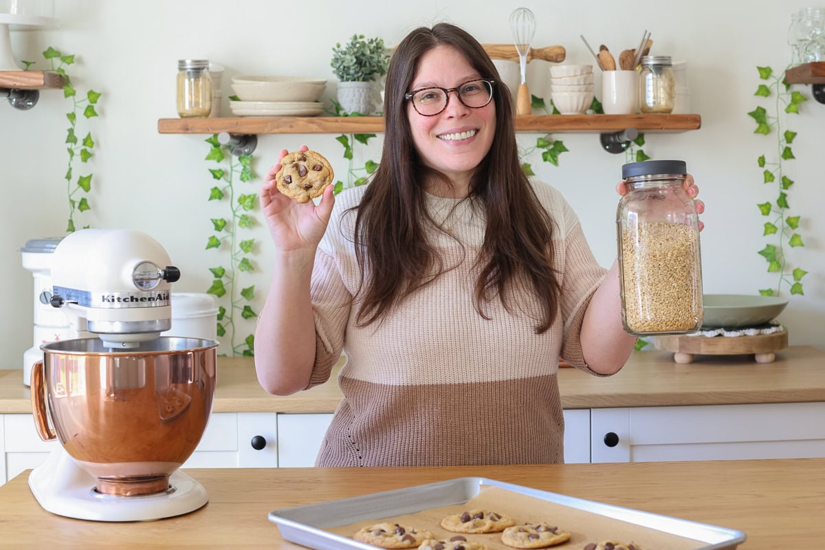 woman holding a cookie and wheat berries.