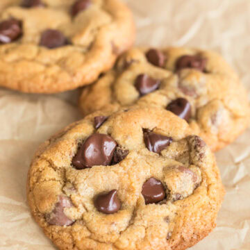 Close-up of fresh milled flour chocolate chip cookies with gooey chocolate chips and golden edges.