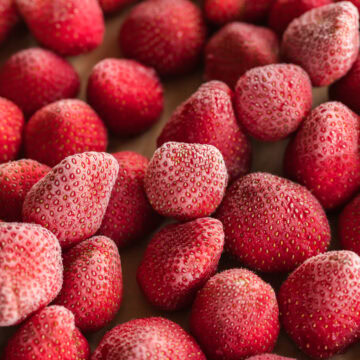 how to freeze strawberries, frozen strawberries on sheet pan.