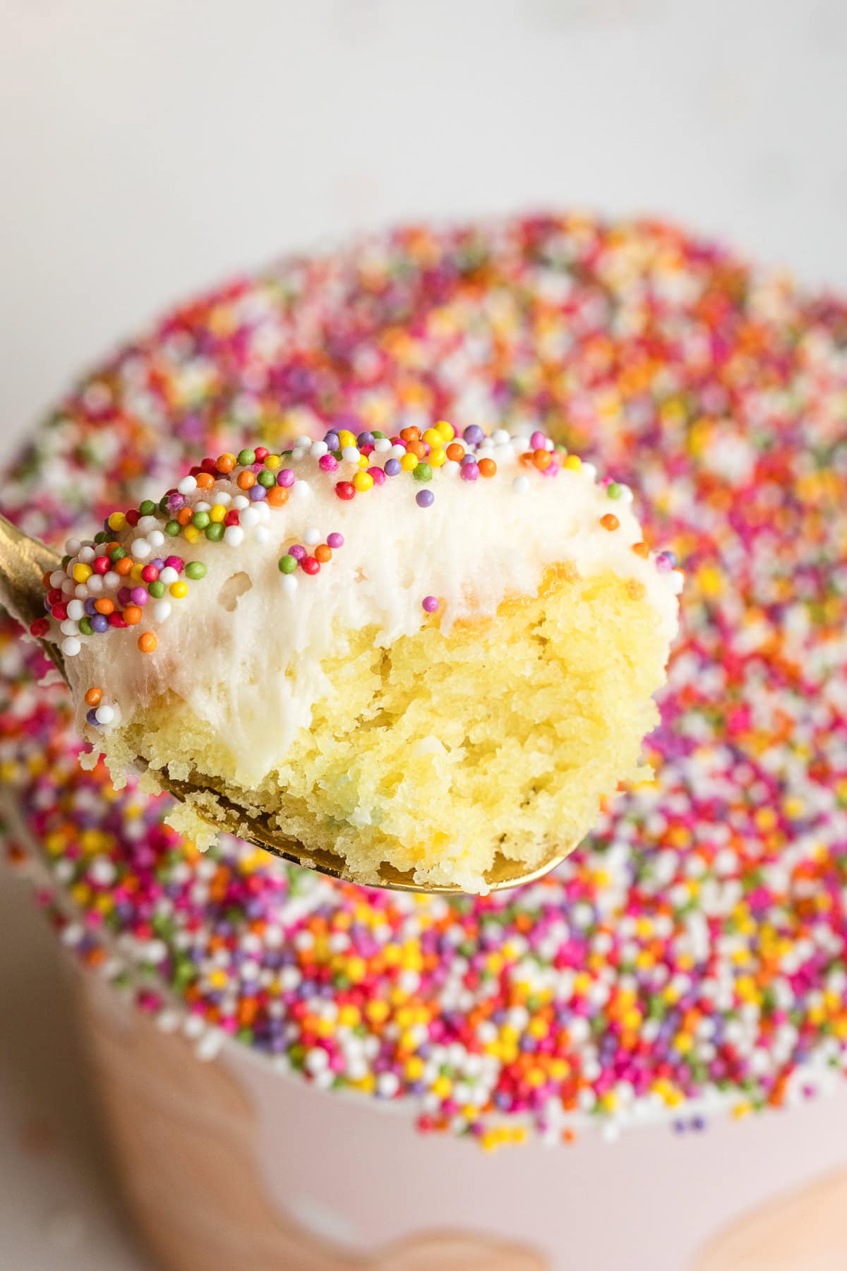 viral sprinkle cake cups like dot cakes with nonpareils spoonful showing a bite from inside.
