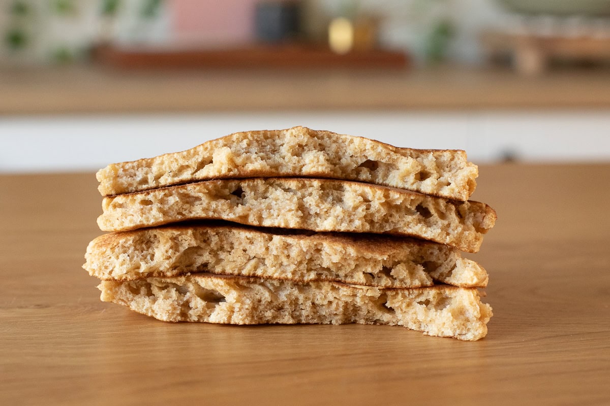 Photo of fresh milled flour pancakes crumb shot, pancakes torn in half and stacked to show texture.