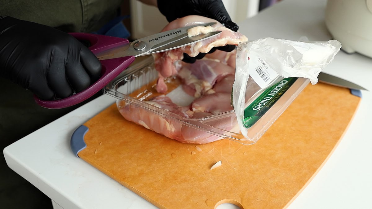 trimming fat off chicken thighs.