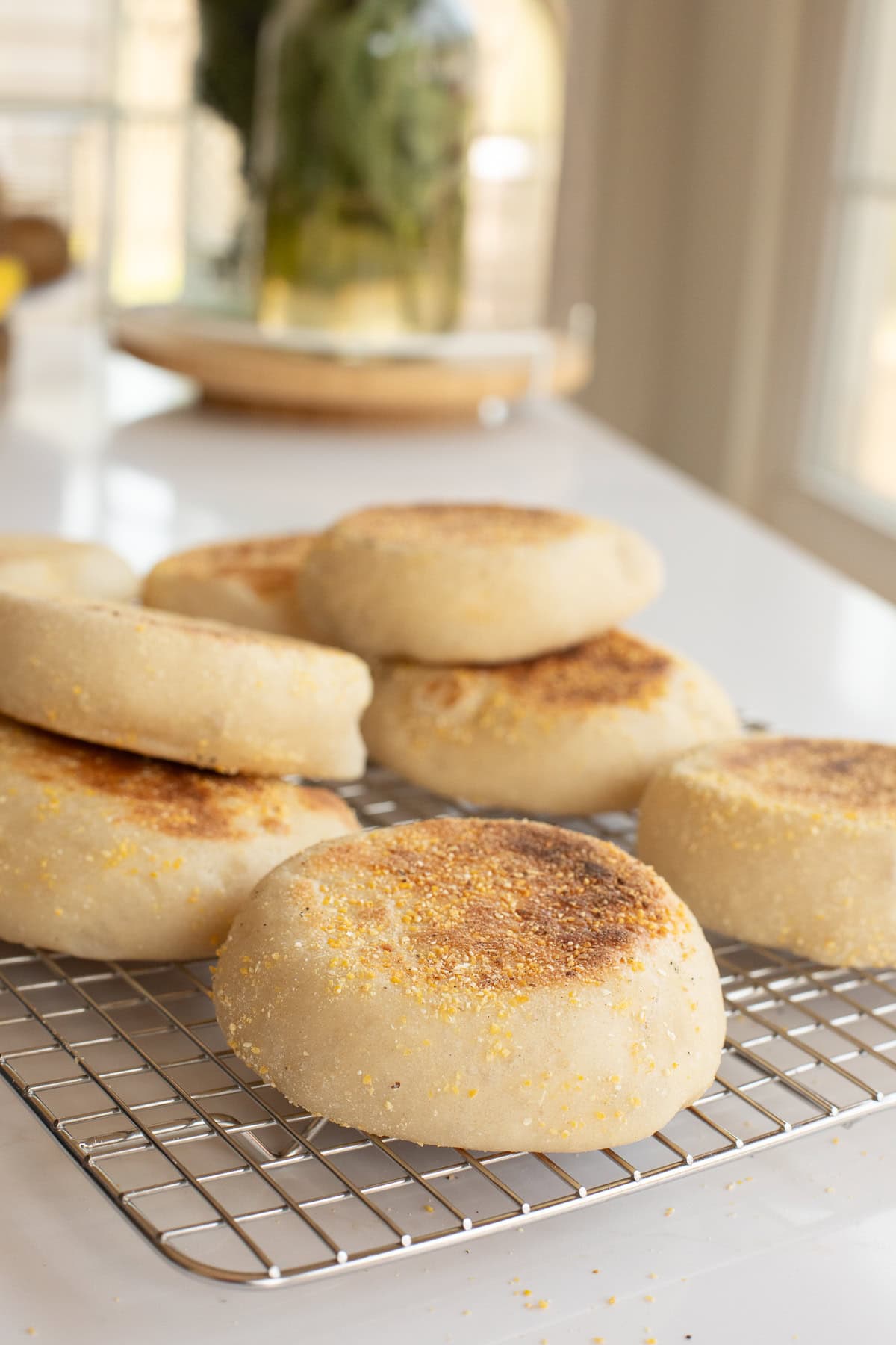 homemade english muffin recipe on a cooling rack.