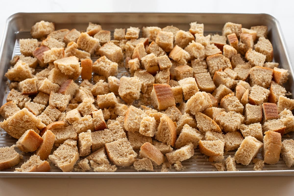 cubed bread on baking sheet.