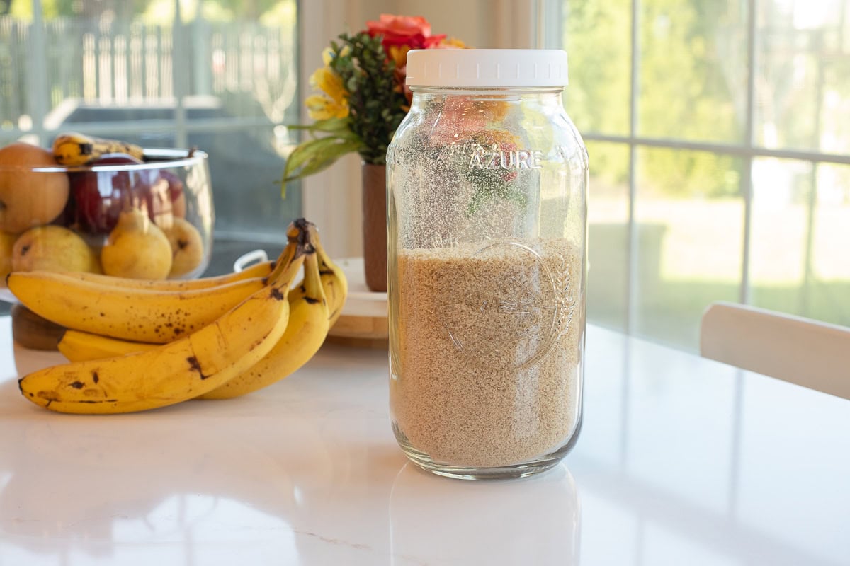 glass mason jar filled with fresh milled flour breadcrumbs.