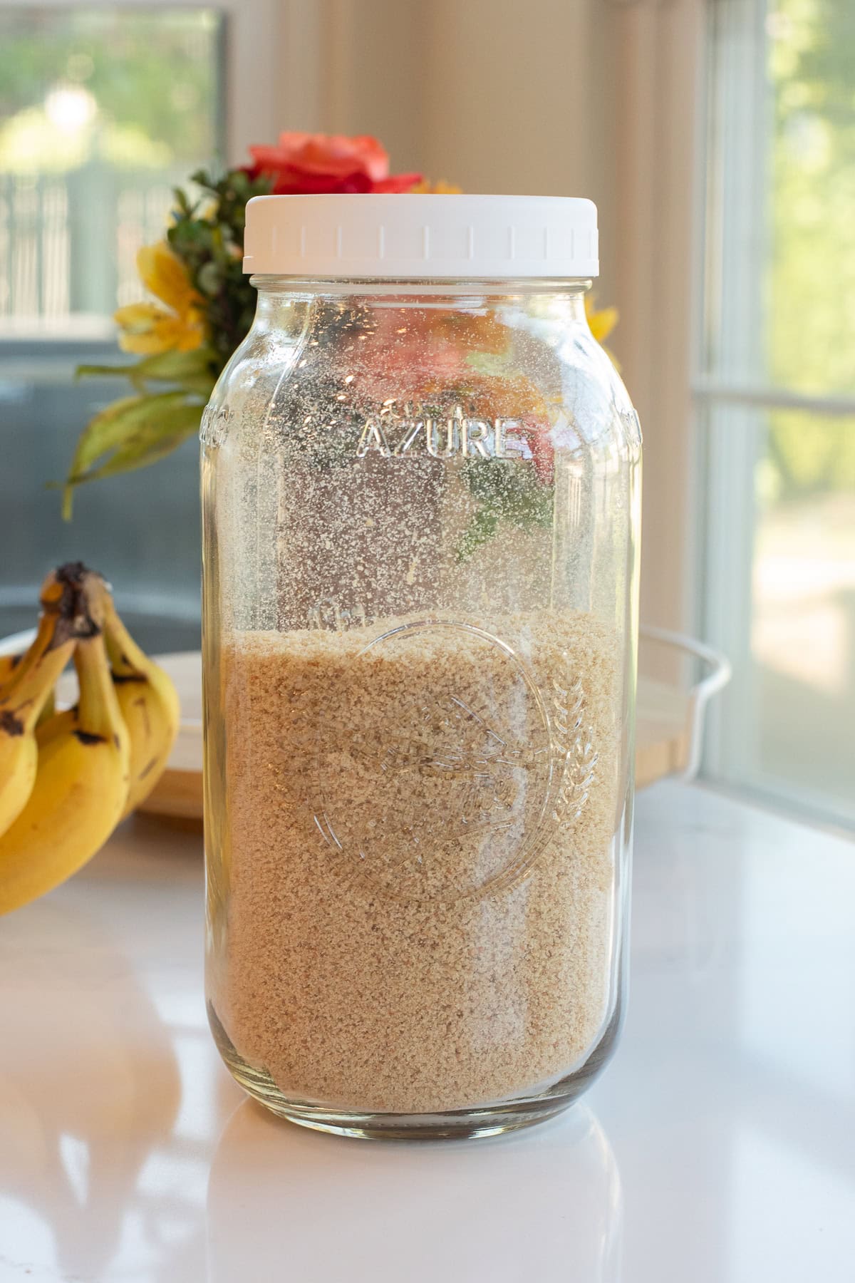 glass jar filled with fresh milled flour breadcrumbs.