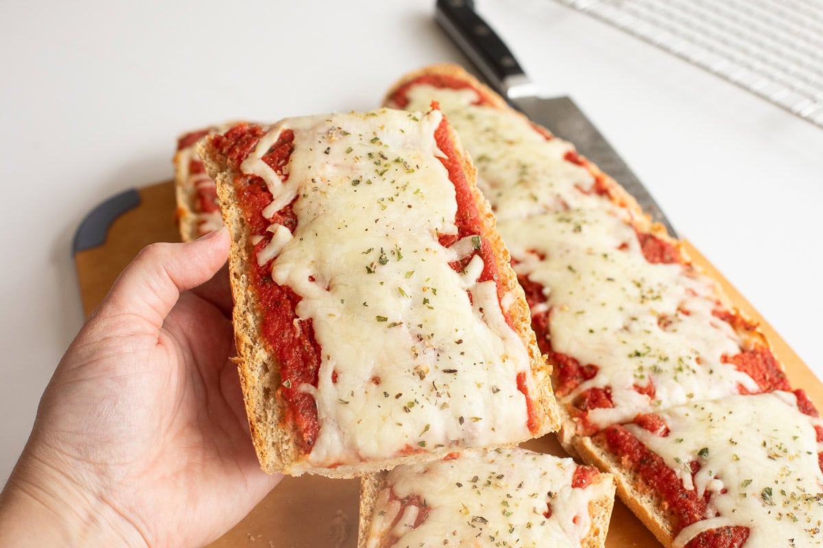 Hand holding Fresh Milled Flour French Bread Pizza.
